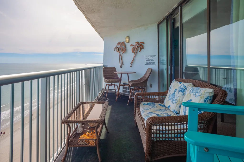 Seating across the penthouse's private balcony overlooking the Atlantic