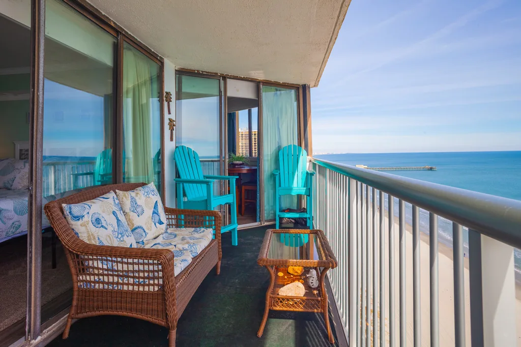 Private balcony with turquoise chairs and an ocean view