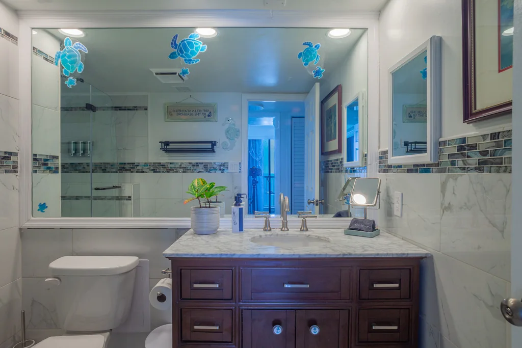 Bathroom with wide vanity and tiled finishes