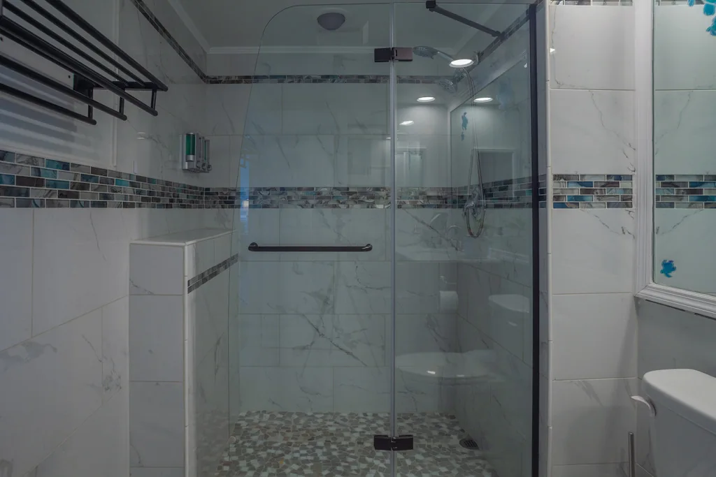 Walk-in tiled shower with glass door