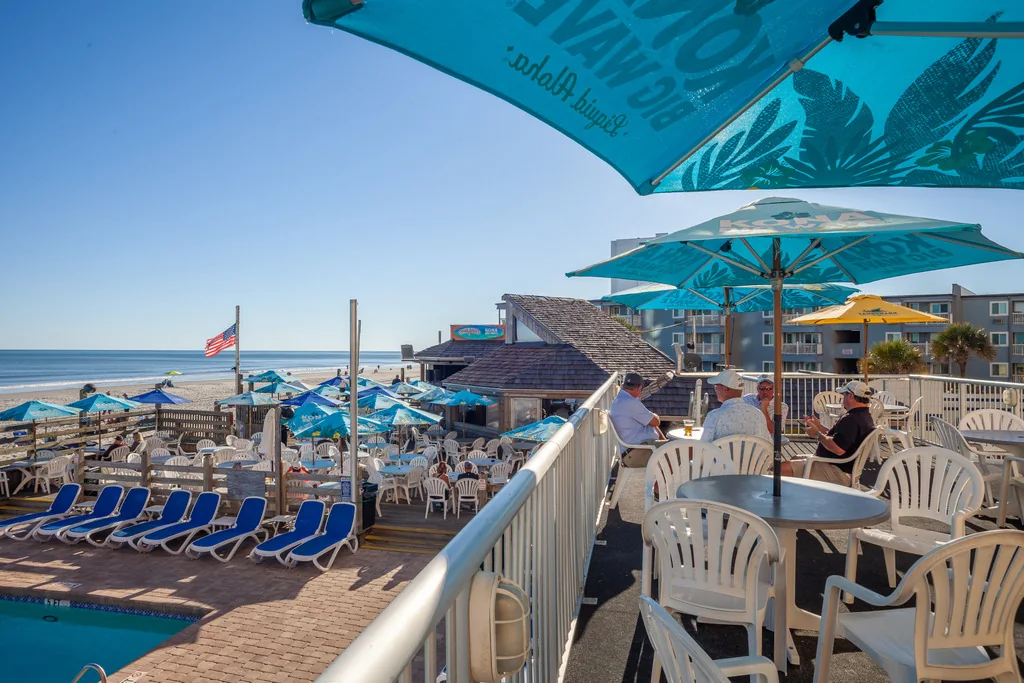 Outdoor beach bar seating overlooking the shoreline